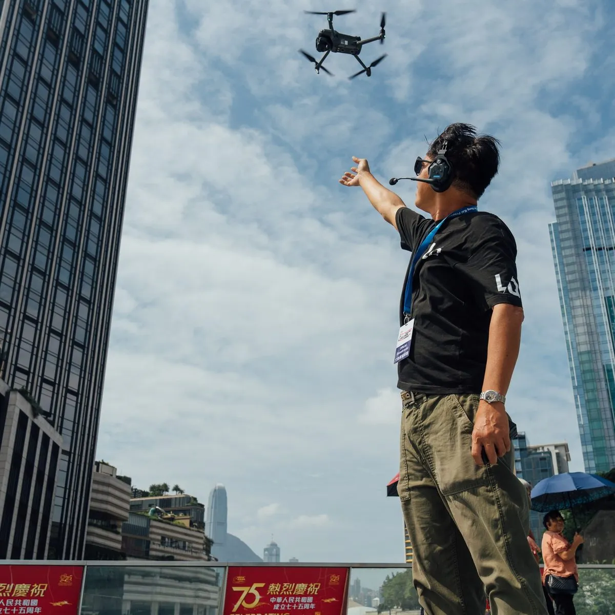 H&A drone pilot flying a quadcopter above the Hong Kong Cyclothon course