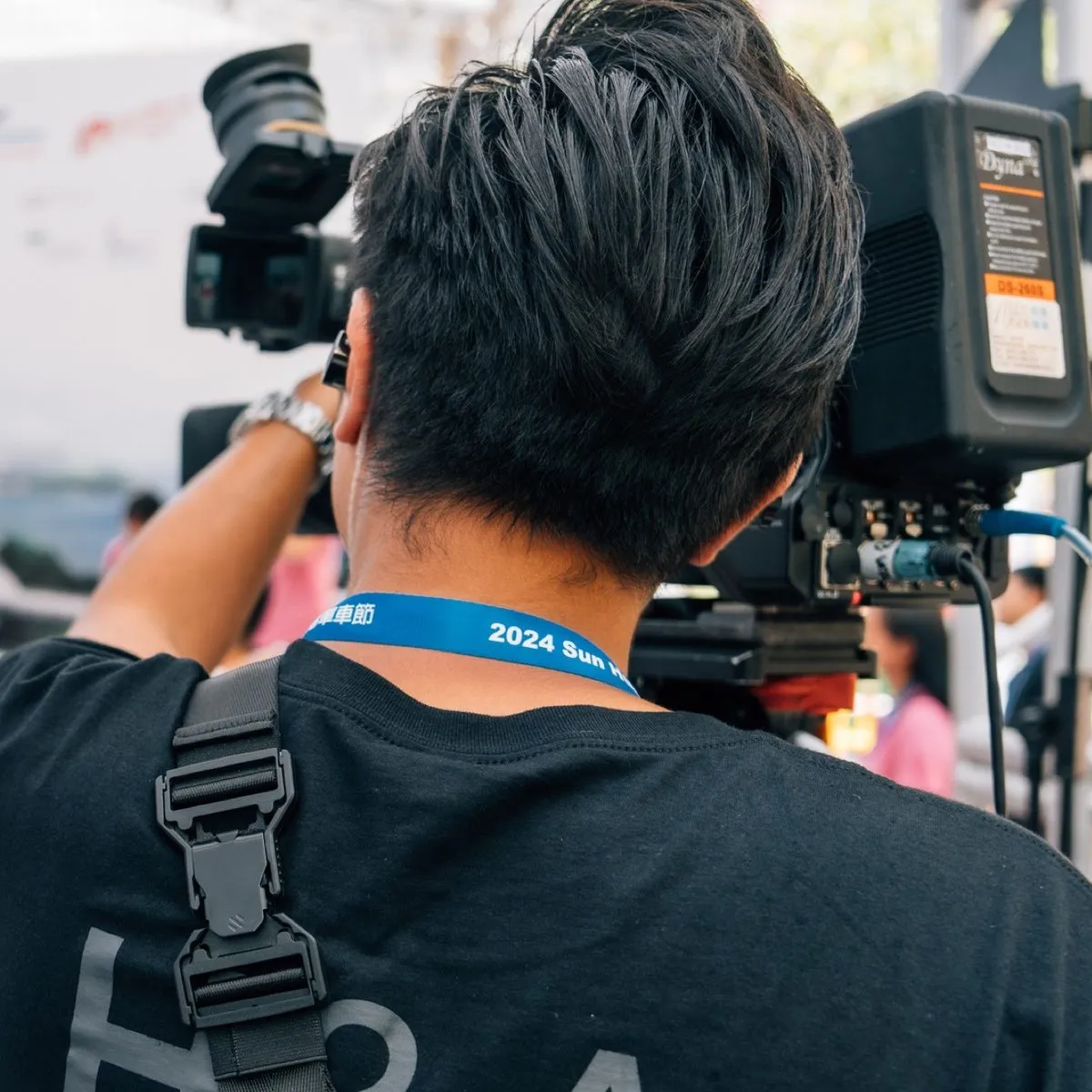 H&A camera operator shouldering an ENG camera at the Hong Kong Cyclothon